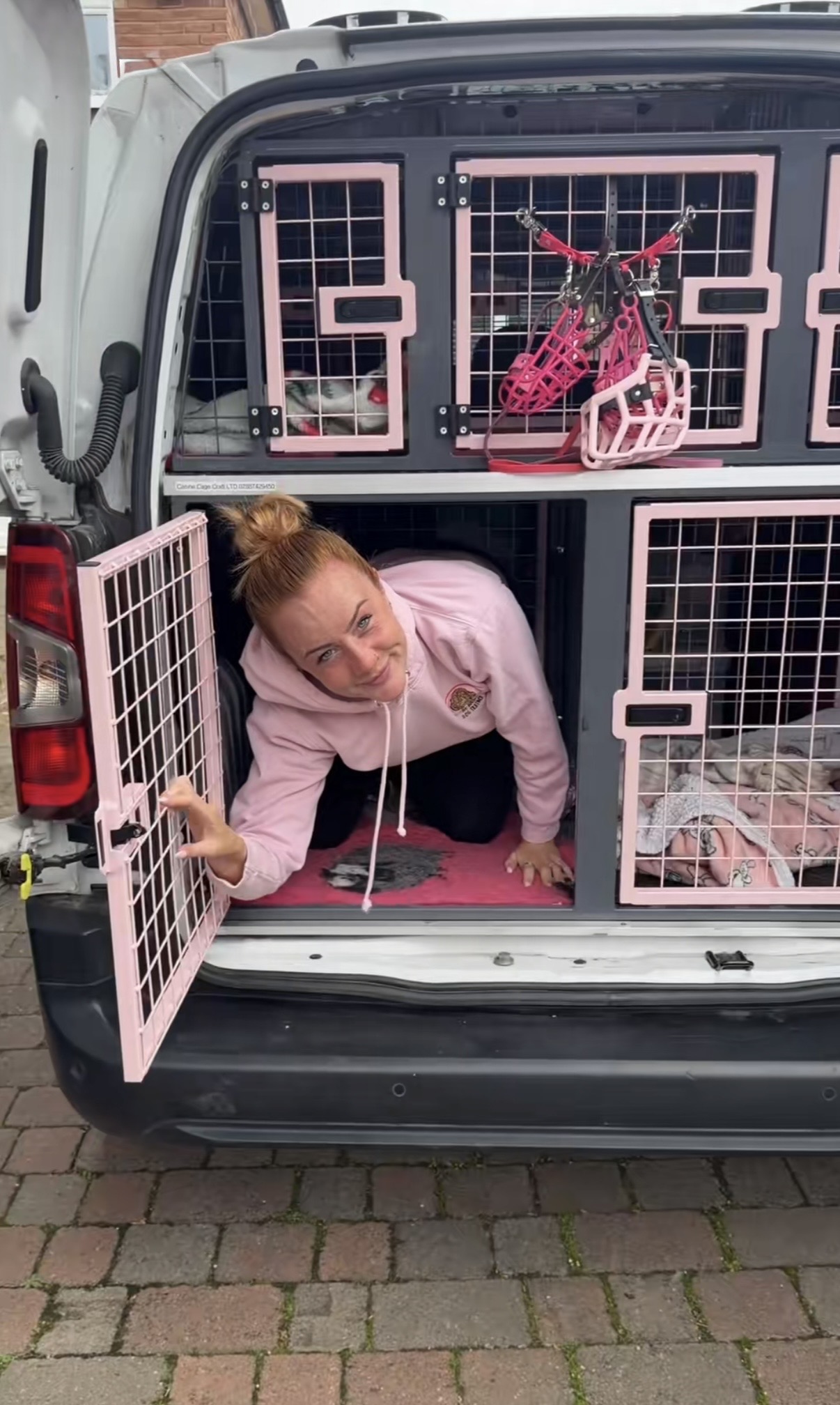 Amy in the pink kennels of her van